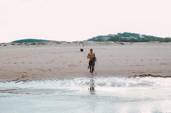 Man Standing By The Beach Holding Net