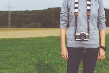 Man Standing Carrying Dslr Camera during Daytime