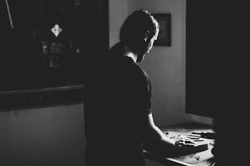 Man Standing Facing on Table