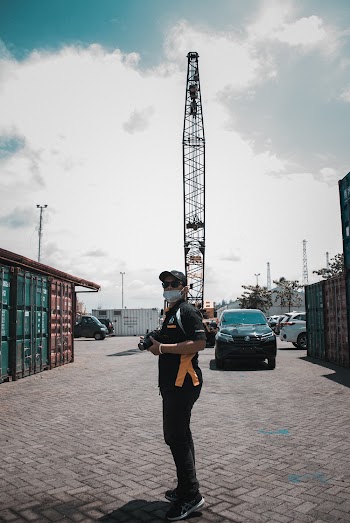 Man Standing Holding Camera 