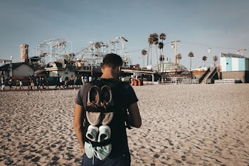 Man Standing in Beach Facing Rides