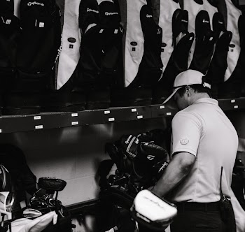 Man Standing in Front of a Golf Bags