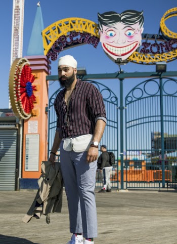 Man  Standing In Front Of A Theme Park Gate