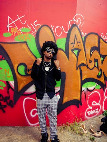 Man Standing In Front Of A Wall