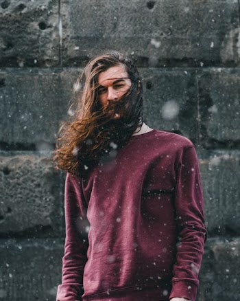 man standing in front of black wall