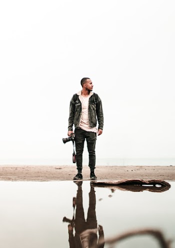 Man Standing in Front of Body of Water