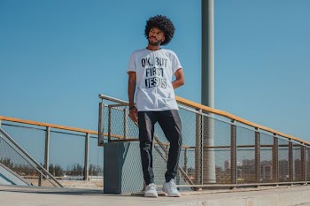 man standing in front of fence
