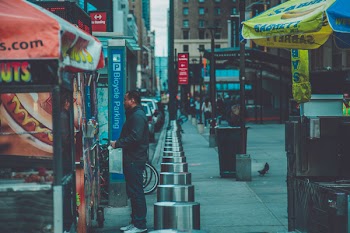 Man Standing in Front of Food Stall