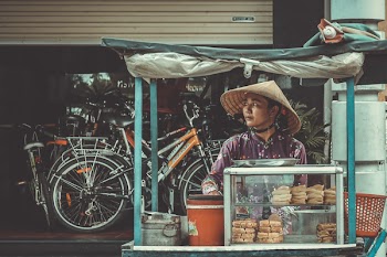 Man Standing in Front of Food Stand