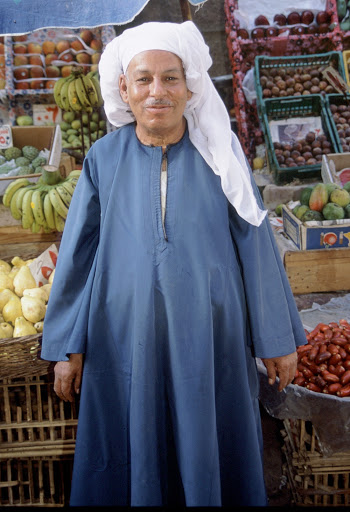 Man Standing in Front of Fruits