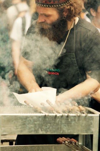 Man Standing in Front of Grill
