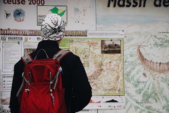 Man Standing in Front of Map