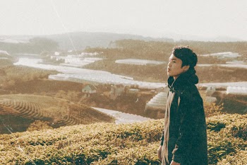 Man Standing in Front of Mountain