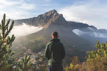 man standing in front of mountain