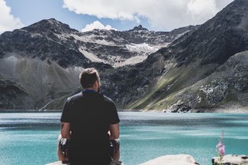 man standing in front of mountain