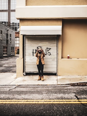 Man Standing in Front of Roller Shutter