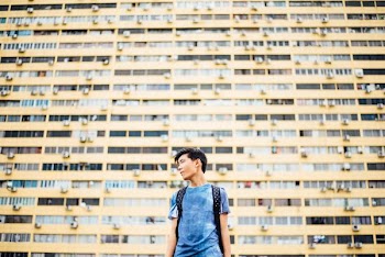man standing in front of skyscraper