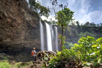 Man Standing in Front of Waterfalls