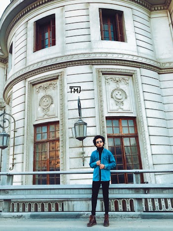 Man Standing in Front of White Concrete Building