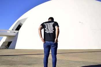 Man Standing in Front of White Structure
