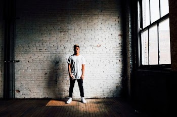 man standing in front of white wall