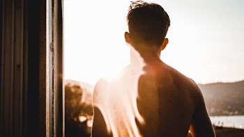 man standing in front of window panel