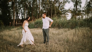 Man Standing in Front of Woman in White Dress