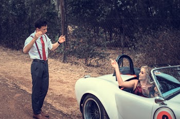 Man Standing in Front of Woman Riding Vehicle