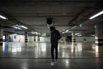 man standing in parking lot