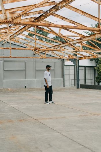 man standing in the middle of roofless building