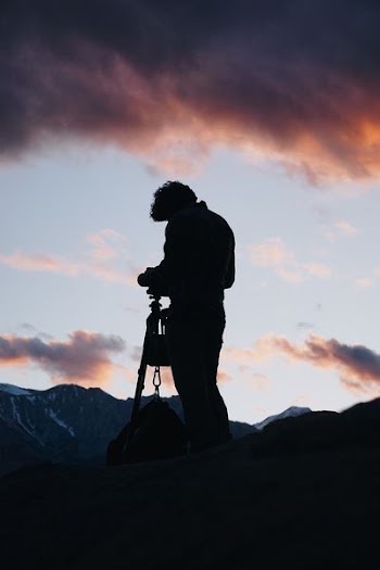 man standing infronting mountain
