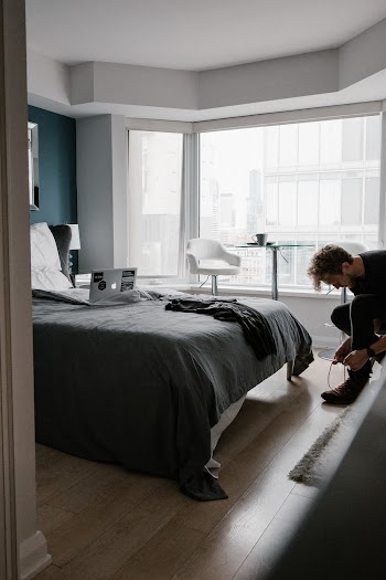 Man Standing Near Bed