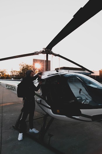 Man Standing Near Black and White Helicopter