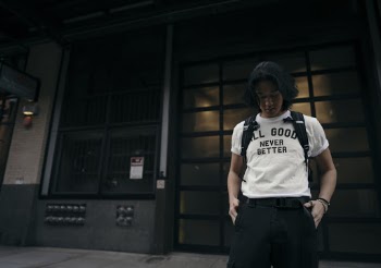 Man Standing Near Black Buildig