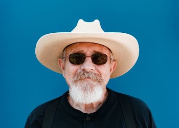 man standing near blue wall