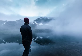 man standing near body of water