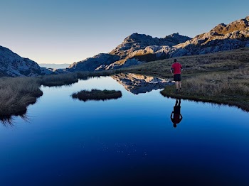 Man Standing Near Body Of Water