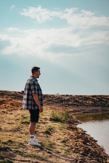 Man Standing Near Body of Water