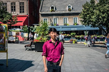Man Standing Near Brown Building