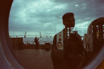 Man Standing Near Clear Glass Mirror