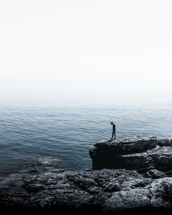 Man Standing Near Cliff