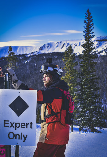 Man Standing Near Expert Only Signage