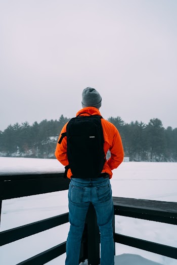 Man Standing Near Fence