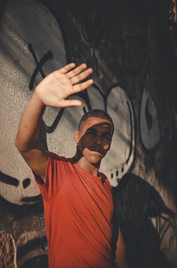 Man Standing Near Graffiti Wall