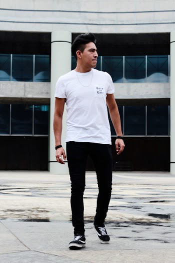 Man Standing Near Gray Building