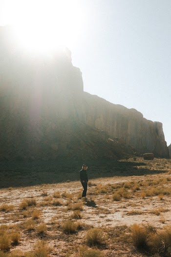 Man Standing Near Gray Mountain