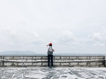 Man Standing Near Grey Wall
