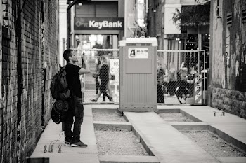 Man Standing Near Keybank Signage