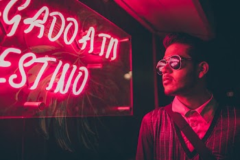 Man Standing Near Led Signage