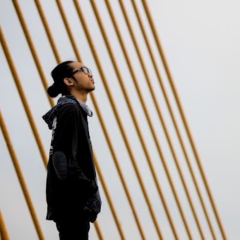 man standing near metal cable